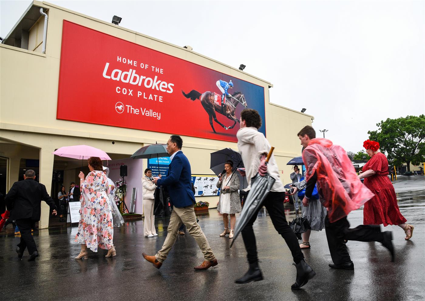 MELBOURNE, AUSTRALIA - OCTOBER 22: Racegoers arrive to attend the Cox Plate Day at Moonee Valley Racecourse on October 22, 2022 in Melbourne, Australia. (Photo by Vince Caligiuri/Getty Images)
