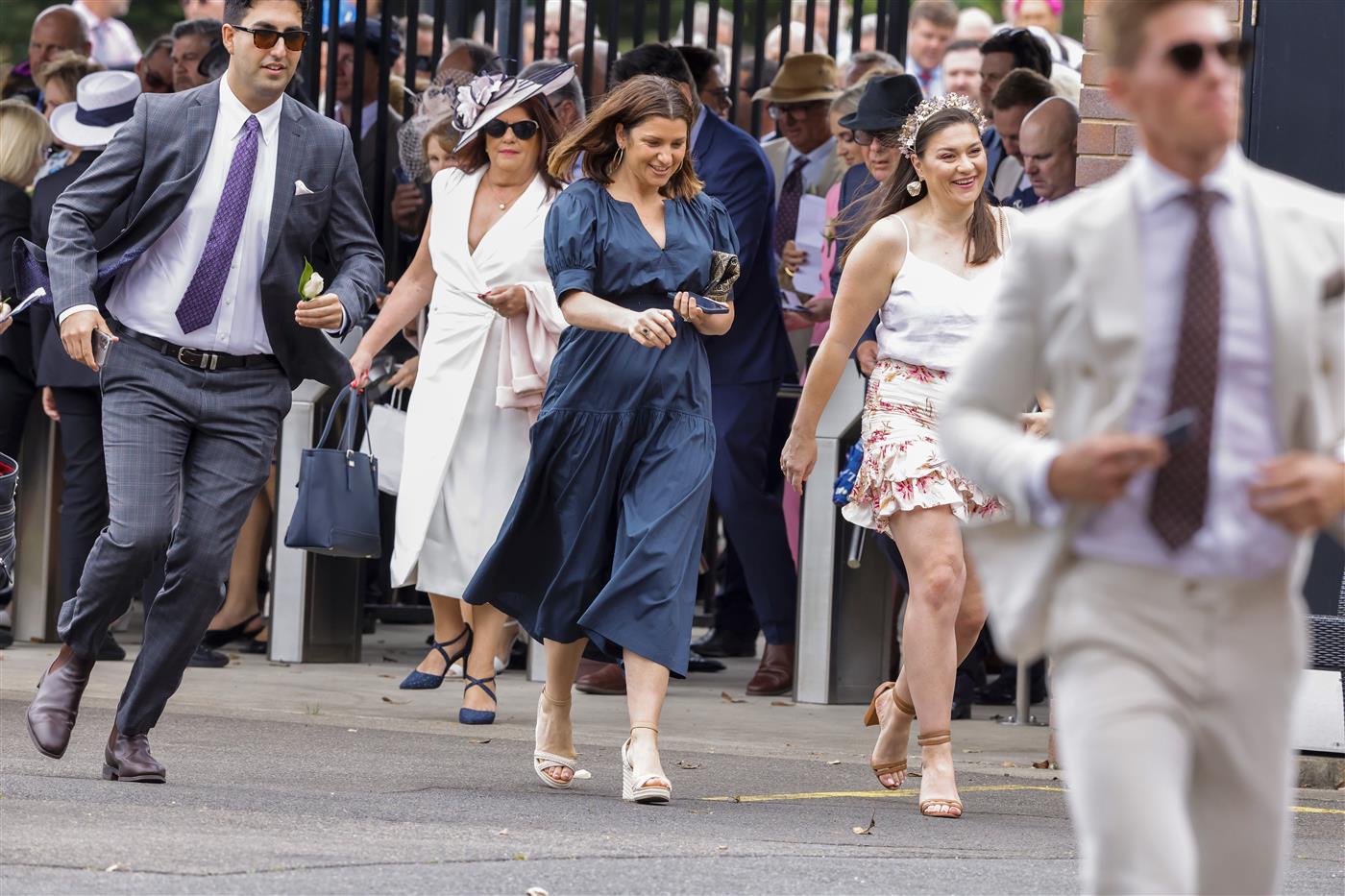 SYDNEY, AUSTRALIA - OCTOBER 22: Racegoers run to get the best spots as the gates open ahead of Spring Champions Stakes Day at Royal Randwick Racecourse on October 22, 2022 in Sydney, Australia. (Photo by Jenny Evans/Getty Images)