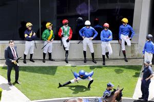 SYDNEY, AUSTRALIA - OCTOBER 22: Jockeys stretch and wait to mount up ahead of race 2 during Spring Champions Stakes Day at Royal Randwick Racecourse on October 22, 2022 in Sydney, Australia. (Photo by Jenny Evans/Getty Images)