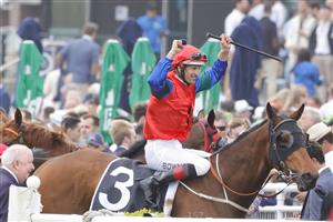 SYDNEY, AUSTRALIA - OCTOBER 22: Hugh Bowman raises his arms in the air after winning race 8 the Moet & Chandon Spring Champion Stakes on Sharp 