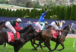 MELBOURNE, AUSTRALIA - OCTOBER 22: James McDonald riding Anamoe defeating Mark Zahra riding I