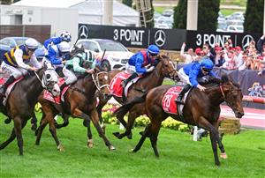 MELBOURNE, AUSTRALIA - OCTOBER 22: James McDonald riding Anamoe defeating Mark Zahra riding I