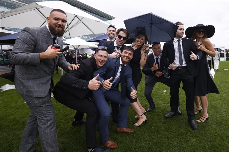MELBOURNE, AUSTRALIA - OCTOBER 29: Racegoers pose for a photograph during 2022 Penfolds Victoria Derby Day at Flemington Racecourse on October 29, 2022 in Melbourne, Australia. (Photo by Daniel Pockett/Getty Images)