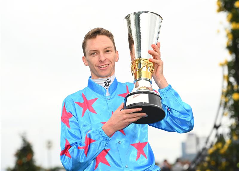 MELBOURNE, AUSTRALIA - OCTOBER 29: Michael Dee poses with the Penfolds Derby trophy after riding Manzoice to win Race 7, the Penfolds Victoria Derby, during 2022 Penfolds Victoria Derby Day at Flemington Racecourse on October 29, 2022 in Melbourne, Australia. (Photo by Vince Caligiuri/Getty Images)