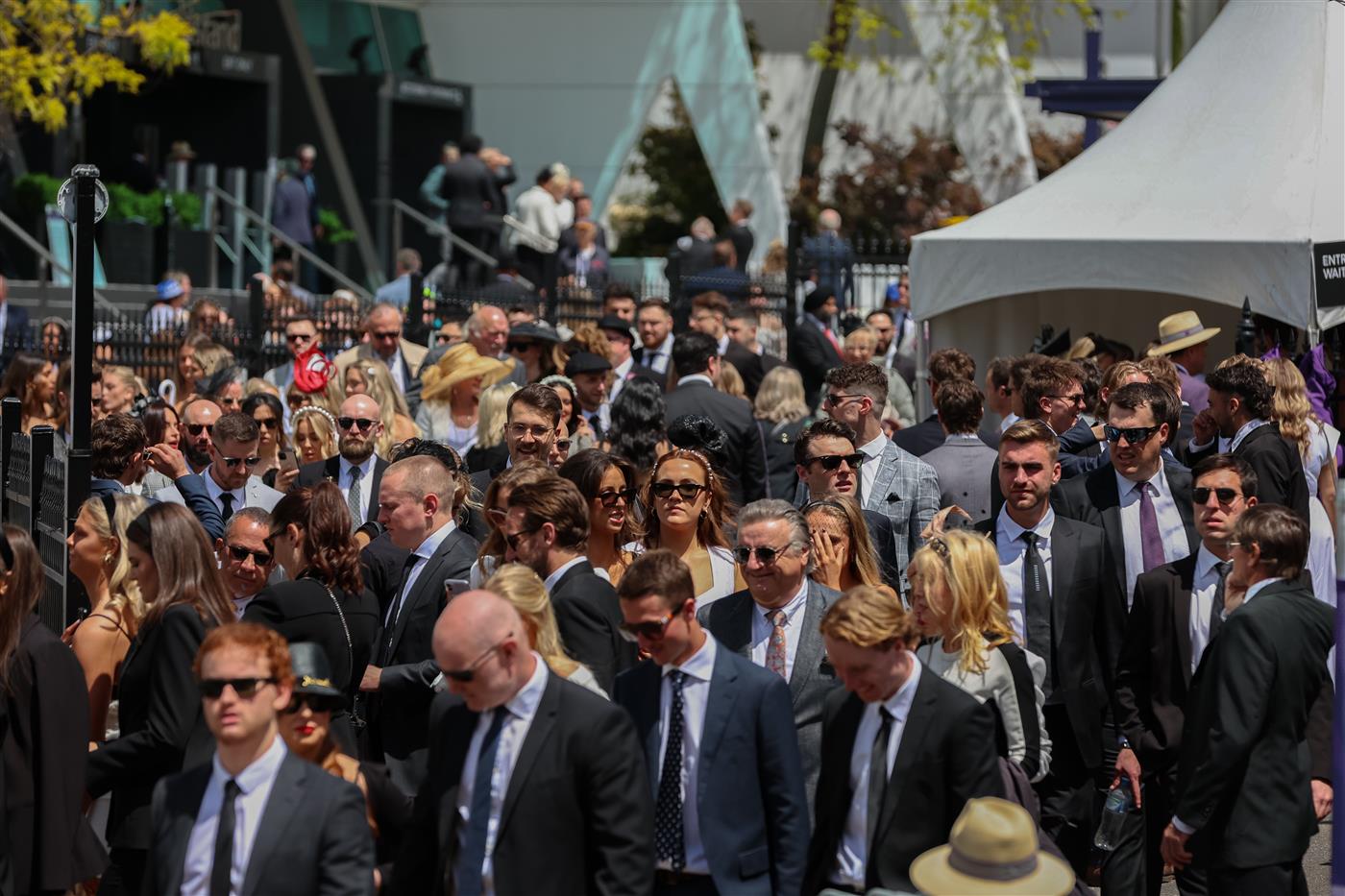 MELBOURNE, AUSTRALIA - OCTOBER 29: Racegoers arrive to  Flemington Racecourse for the 2022 AAMI Victoria Derby Day at Flemington Racecourse on October 29, 2022 in Melbourne, Australia. (Photo by Asanka Ratnayake/Getty Images)