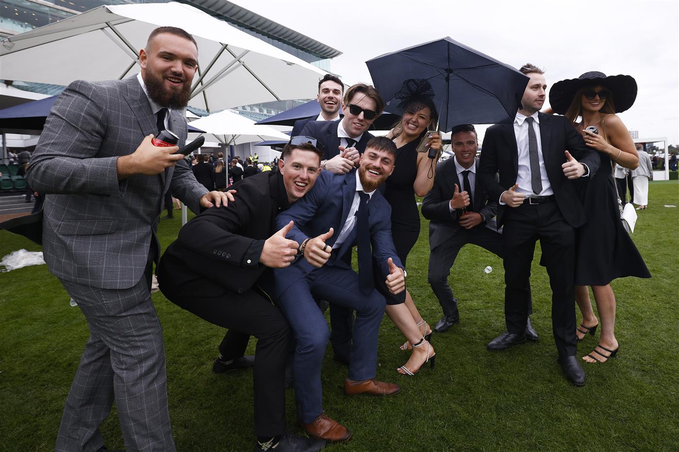 MELBOURNE, AUSTRALIA - OCTOBER 29: Racegoers pose for a photograph during 2022 Penfolds Victoria Derby Day at Flemington Racecourse on October 29, 2022 in Melbourne, Australia. (Photo by Daniel Pockett/Getty Images)