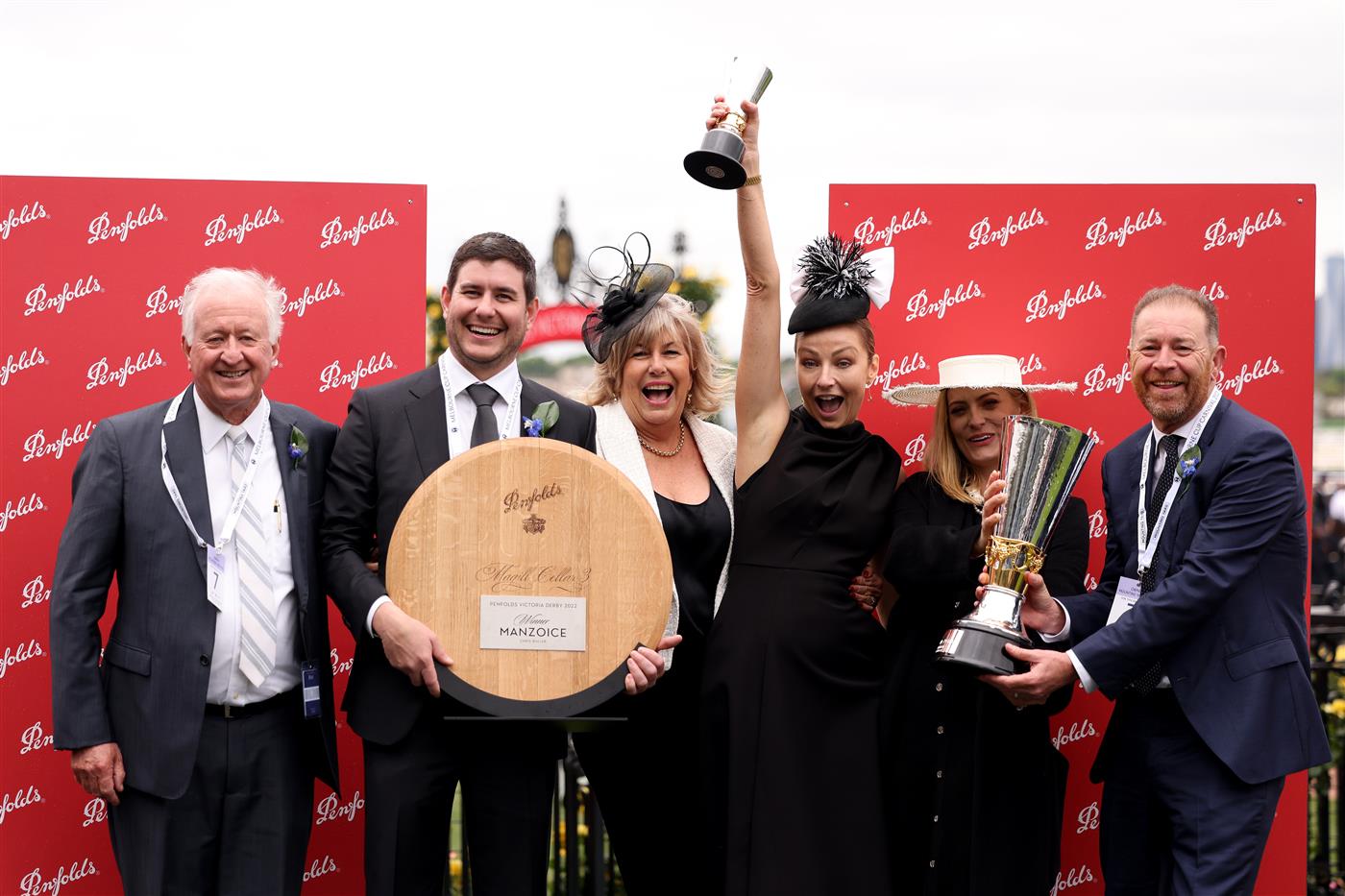 MELBOURNE, AUSTRALIA - OCTOBER 29: The winnning team of Manzoice pose for a photoafter winning Race 7, the Penfolds Victoria Derby,  during 2022 Penfolds Victoria Derby Day at Flemington Racecourse on October 29, 2022 in Melbourne, Australia. (Photo by Jonathan DiMaggio/Getty Images for VRC)