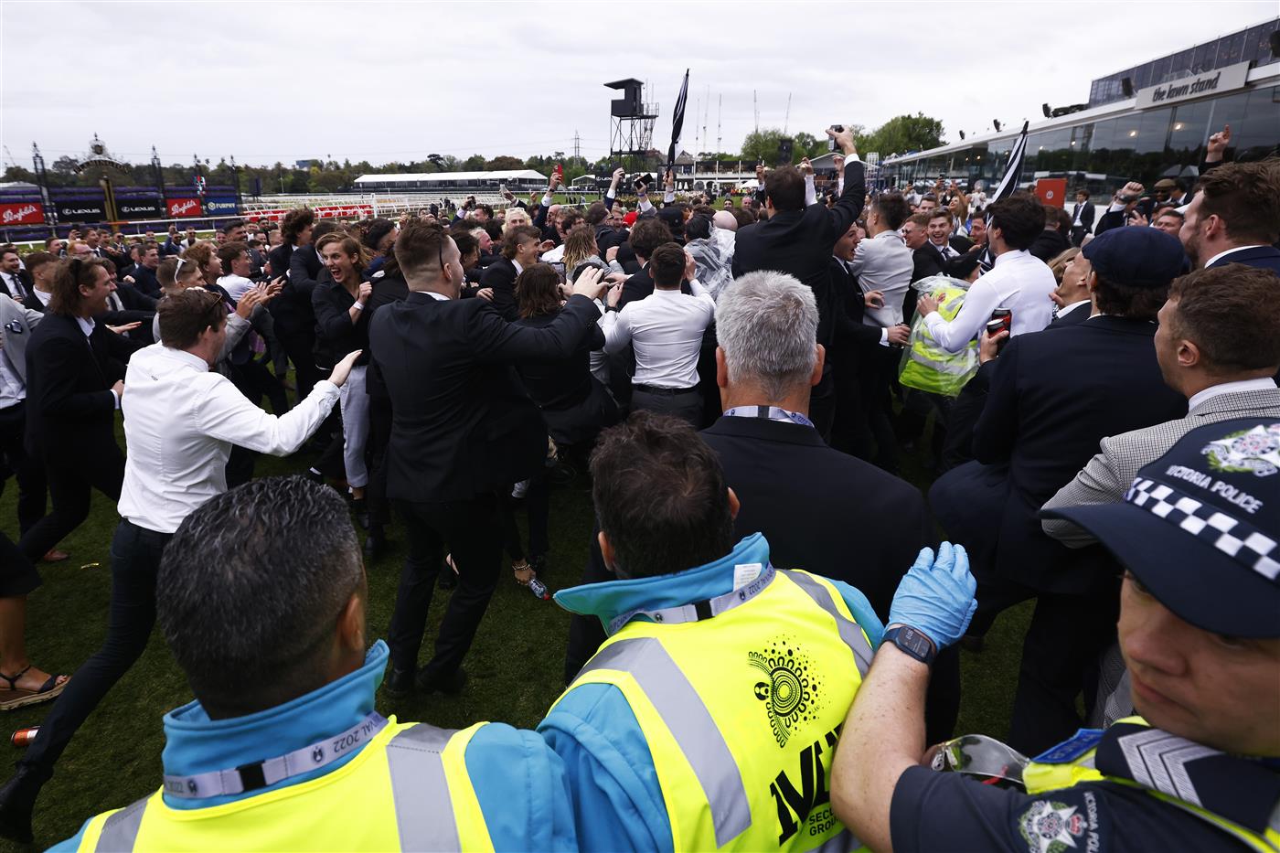 MELBOURNE, AUSTRALIA - OCTOBER 29: Police and security attempt to break up a large crowd of racegoers for unsocial behaviour after the final race during 2022 Penfolds Victoria Derby Day at Flemington Racecourse on October 29, 2022 in Melbourne, Australia. (Photo by Daniel Pockett/Getty Images)