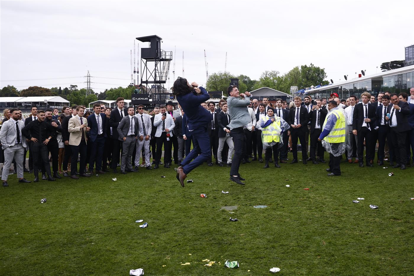 MELBOURNE, AUSTRALIA - OCTOBER 29: Police and security attempt to break up a large crowd of racegoers for unsocial behaviour after the final race during 2022 Penfolds Victoria Derby Day at Flemington Racecourse on October 29, 2022 in Melbourne, Australia. (Photo by Daniel Pockett/Getty Images)