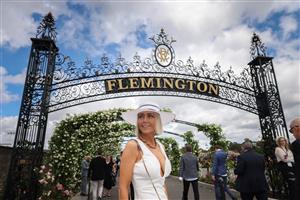 MELBOURNE, AUSTRALIA - OCTOBER 29: A racegoer poses for a photo as she arrives at Flemington Racecourse for the 2022 AAMI Victoria Derby Day at Flemington Racecourse on October 29, 2022 in Melbourne, Australia. (Photo by Asanka Ratnayake/Getty Images)