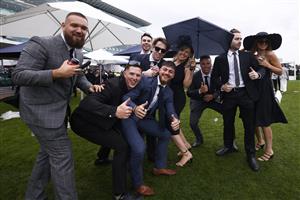 MELBOURNE, AUSTRALIA - OCTOBER 29: Racegoers pose for a photograph during 2022 Penfolds Victoria Derby Day at Flemington Racecourse on October 29, 2022 in Melbourne, Australia. (Photo by Daniel Pockett/Getty Images)