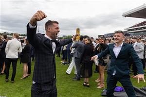 MELBOURNE, AUSTRALIA - OCTOBER 29: A racegoer celebrates at the conclusion of a race during 2022 Penfolds Victoria Derby Day at Flemington Racecourse on October 29, 2022 in Melbourne, Australia. (Photo by Asanka Ratnayake/Getty Images)