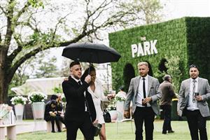 MELBOURNE, AUSTRALIA - OCTOBER 29: Punters take cover from the rain at The Park, during 2022 Penfolds Victoria Derby Day at Flemington Racecourse on October 29, 2022 in Melbourne, Australia. (Photo by Naomi Rahim/Getty Images for VRC)