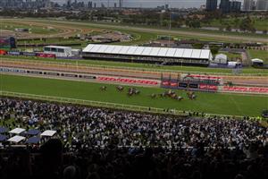 MELBOURNE, AUSTRALIA - OCTOBER 29: A general view as spectators watch Michael Dee riding horse Manzoice passing the finishing post to win the Penfolds Victoria Derby during 2022 Penfolds Victoria Derby Day at Flemington Racecourse on October 29, 2022 in Melbourne, Australia. (Photo by Asanka Ratnayake/Getty Images)