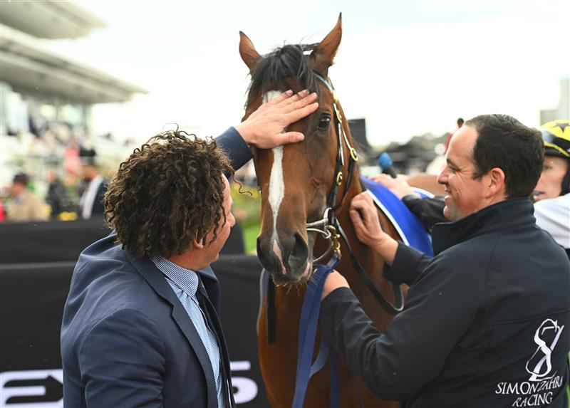 MELBOURNE, AUSTRALIA - NOVEMBER 01: Trainer Simon Zahra poses with Krakarib after winning Race 1, the Darley Maribyrnong Plate, during 2022 Lexus Melbourne Cup Day at Flemington Racecourse on November 01, 2022 in Melbourne, Australia. (Photo by Vince Caligiuri/Getty Images)