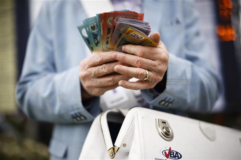 MELBOURNE, AUSTRALIA - NOVEMBER 01: A detail of a bookie holding cash is seen during 2022 Lexus Melbourne Cup Day at Flemington Racecourse on November 01, 2022 in Melbourne, Australia. (Photo by Daniel Pockett/Getty Images)