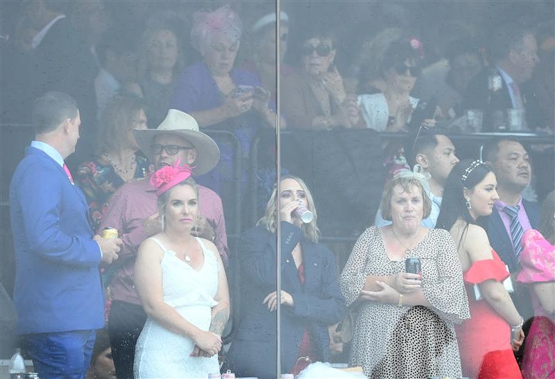 MELBOURNE, AUSTRALIA - NOVEMBER 01: Fans watch from inside during 2022 Lexus Melbourne Cup Day at Flemington Racecourse on November 01, 2022 in Melbourne, Australia. (Photo by Quinn Rooney/Getty Images)