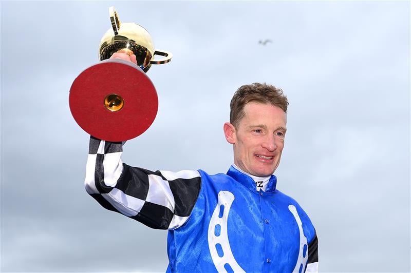 MELBOURNE, AUSTRALIA - NOVEMBER 01: Mark Zahra who rode Gold Trip celebrates with the trophy after winning race seven, the Lexus Melbourne Cup during 2022 Lexus Melbourne Cup Day at Flemington Racecourse on November 01, 2022 in Melbourne, Australia. (Photo by Quinn Rooney/Getty Images)