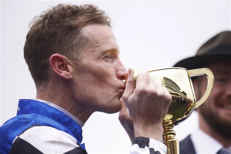 MELBOURNE, AUSTRALIA - NOVEMBER 01: Mark Zahra who rode Gold Trip (C) celebrates with the trophy after winning race seven, the Lexus Melbourne Cup during 2022 Lexus Melbourne Cup Day at Flemington Racecourse on November 01, 2022 in Melbourne, Australia. (Photo by Daniel Pockett/Getty Images)