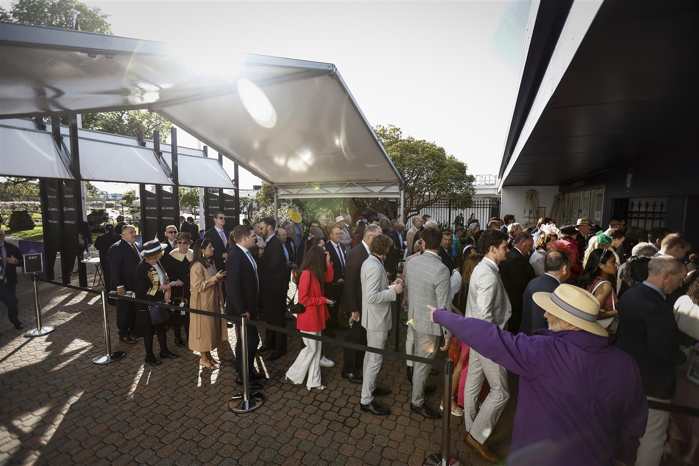 MELBOURNE, AUSTRALIA - NOVEMBER 01: Racing fans line up before the gates open during 2022 Melbourne Cup Day at Flemington Racecourse on November 01, 2022 in Melbourne, Australia. (Photo by Darrian Traynor/Getty Images)