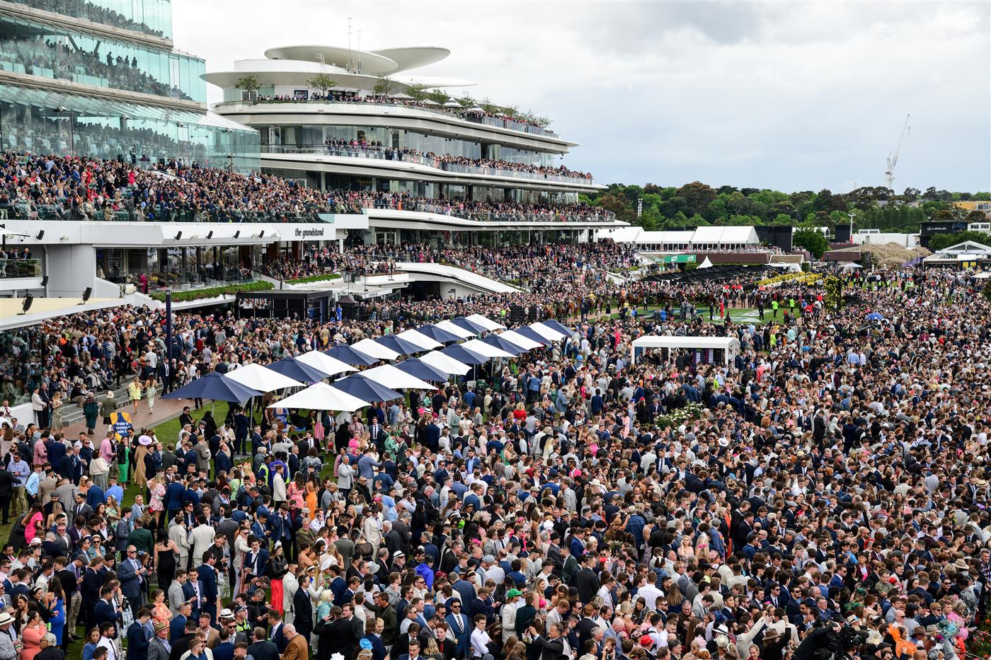 MELBOURNE, AUSTRALIA - NOVEMBER 01: General view of crowd as horses walk onto the track before Race 7, the Lexus Melbourne Cup, during 2022 Lexus Melbourne Cup Day at Flemington Racecourse on November 01, 2022 in Melbourne, Australia. (Photo by Vince Caligiuri/Getty Images)