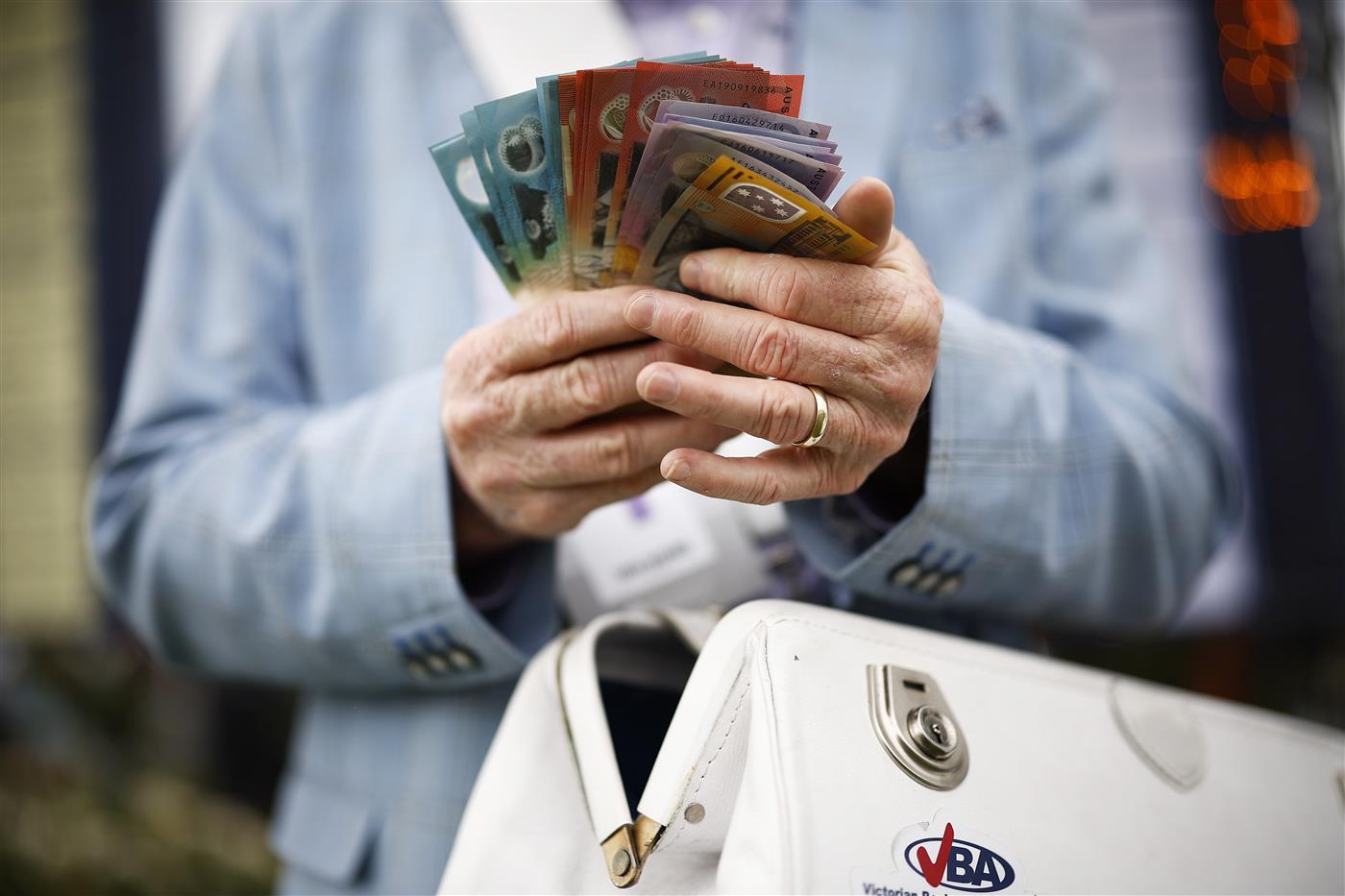 MELBOURNE, AUSTRALIA - NOVEMBER 01: A detail of a bookie holding cash is seen during 2022 Lexus Melbourne Cup Day at Flemington Racecourse on November 01, 2022 in Melbourne, Australia. (Photo by Daniel Pockett/Getty Images)