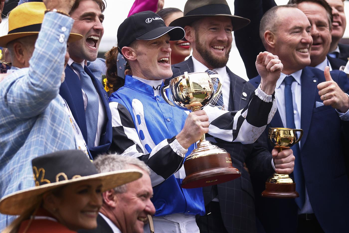 MELBOURNE, AUSTRALIA - NOVEMBER 01: Mark Zahra who rode Gold Trip (C) celebrates with the trophy after winning race seven, the Lexus Melbourne Cup during 2022 Lexus Melbourne Cup Day at Flemington Racecourse on November 01, 2022 in Melbourne, Australia. (Photo by Daniel Pockett/Getty Images)
