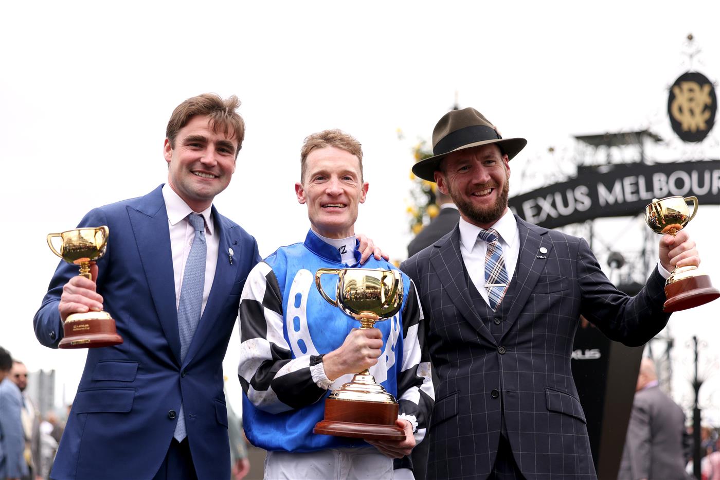 MELBOURNE, AUSTRALIA - NOVEMBER 01: Trainers David Eustace, Ciaron Maher and jockey Mark Zahra pose with the Melbourne Cup after Gold Trip won Race 7, the Lexus Melbourne Cup, during 2022 Melbourne Cup Day at Flemington Racecourse on November 01, 2022 in Melbourne, Australia. (Photo by Jonathan DiMaggio/Getty Images for VRC)