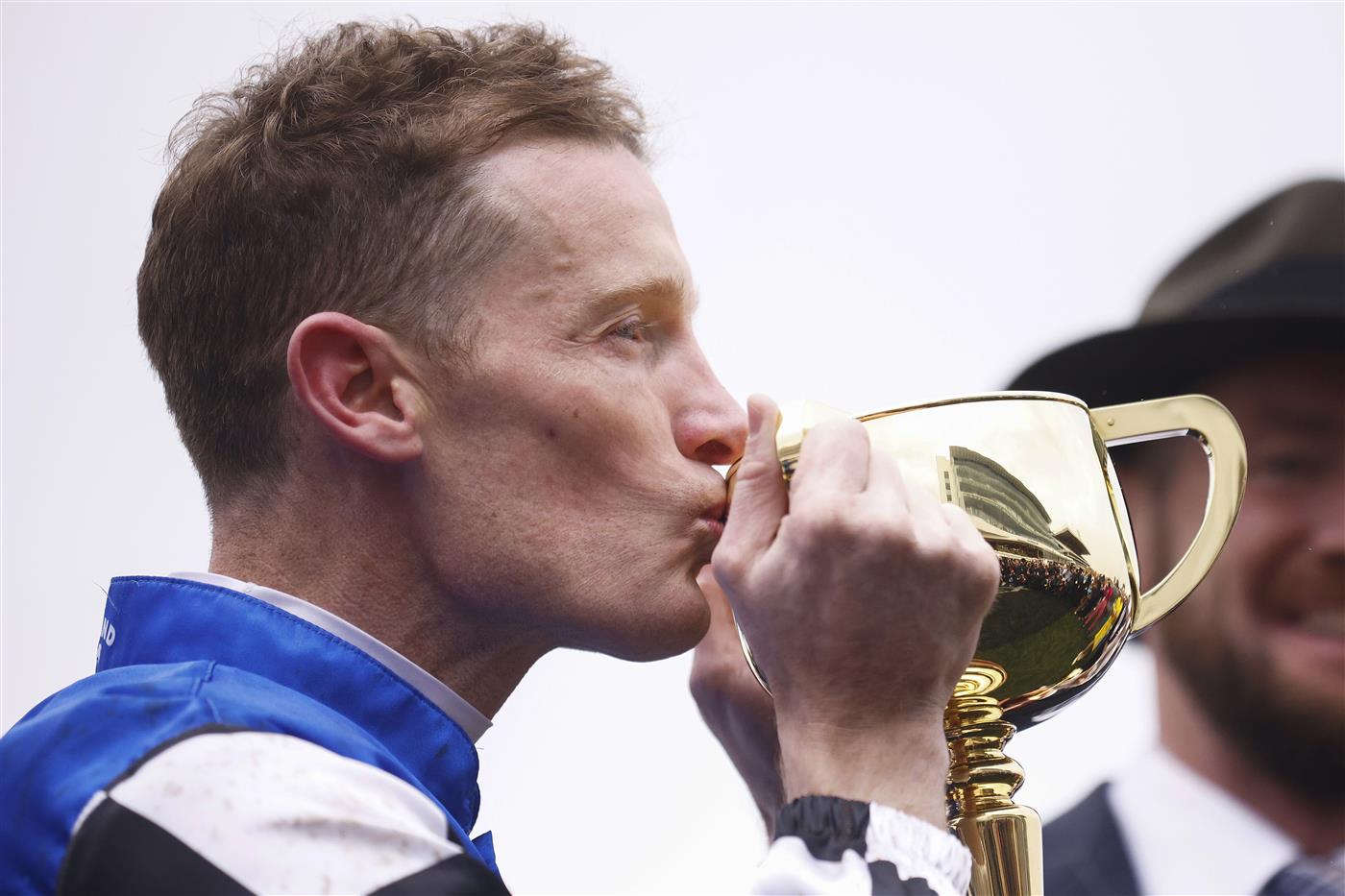 MELBOURNE, AUSTRALIA - NOVEMBER 01: Mark Zahra who rode Gold Trip (C) celebrates with the trophy after winning race seven, the Lexus Melbourne Cup during 2022 Lexus Melbourne Cup Day at Flemington Racecourse on November 01, 2022 in Melbourne, Australia. (Photo by Daniel Pockett/Getty Images)