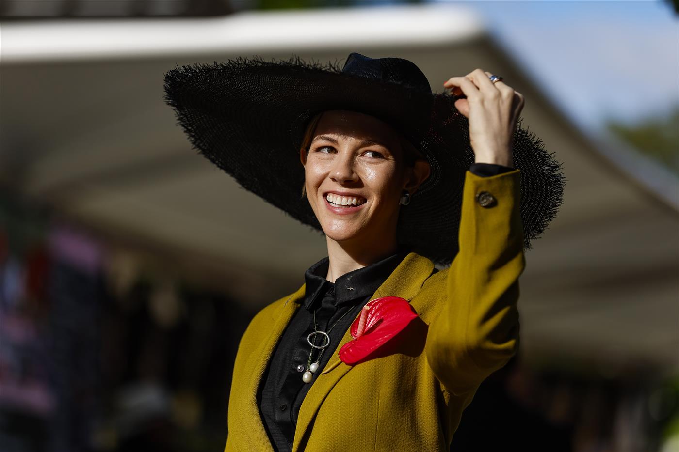 MELBOURNE, AUSTRALIA - NOVEMBER 03: A racegoer poses for a photo during 2022 Oaks Day at Flemington Racecourse on November 03, 2022 in Melbourne, Australia. (Photo by Luke Hemer/Getty Images for VRC)
