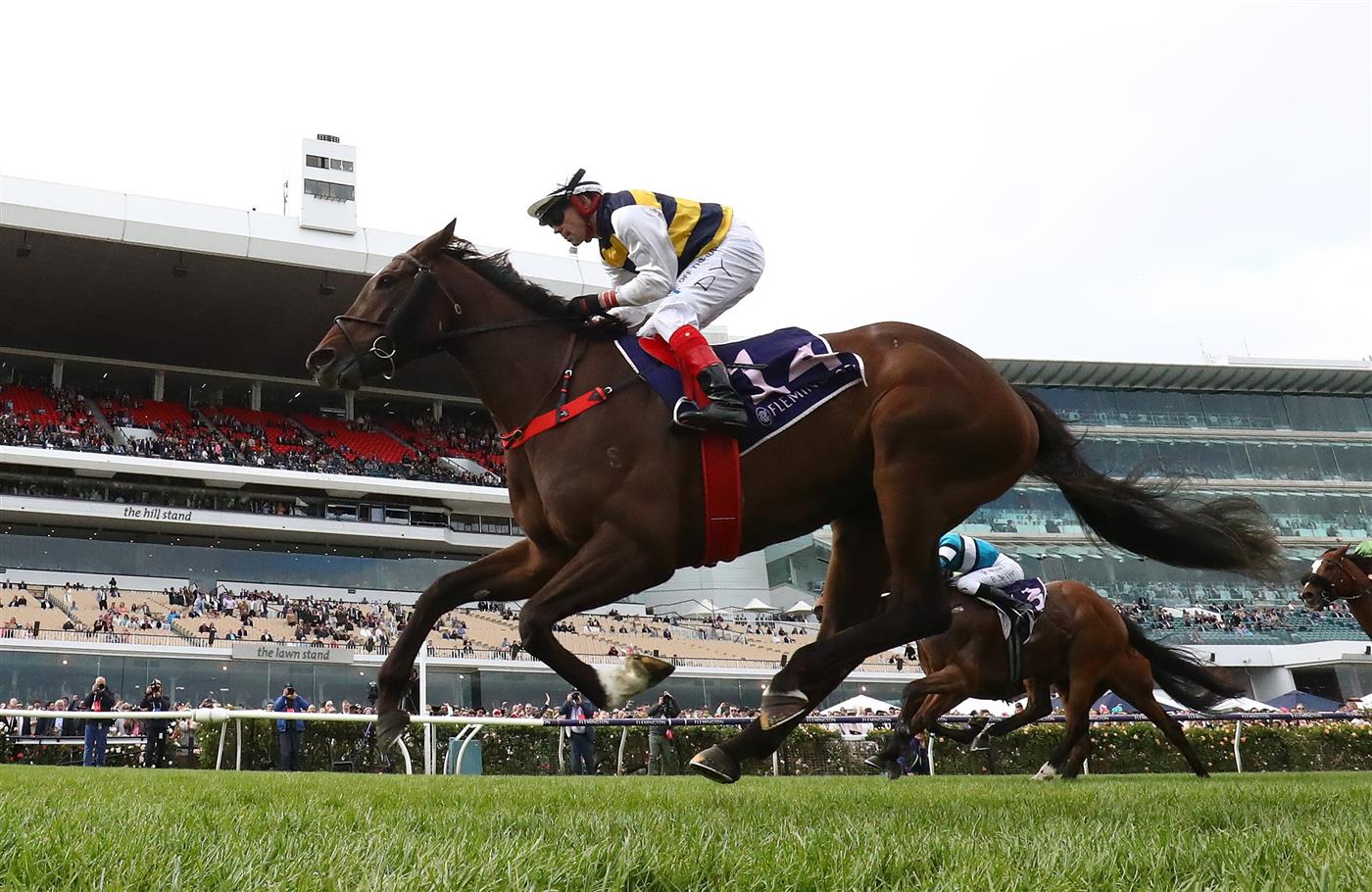 MELBOURNE, AUSTRALIA - NOVEMBER 03: Dean Yendall rides #14 Toregene to win the Melbourne Cup Carnival Country Final during 2022 Kennedy Oaks Day at Flemington Racecourse on November 03, 2022 in Melbourne, Australia. (Photo by Robert Cianflone/Getty Images)