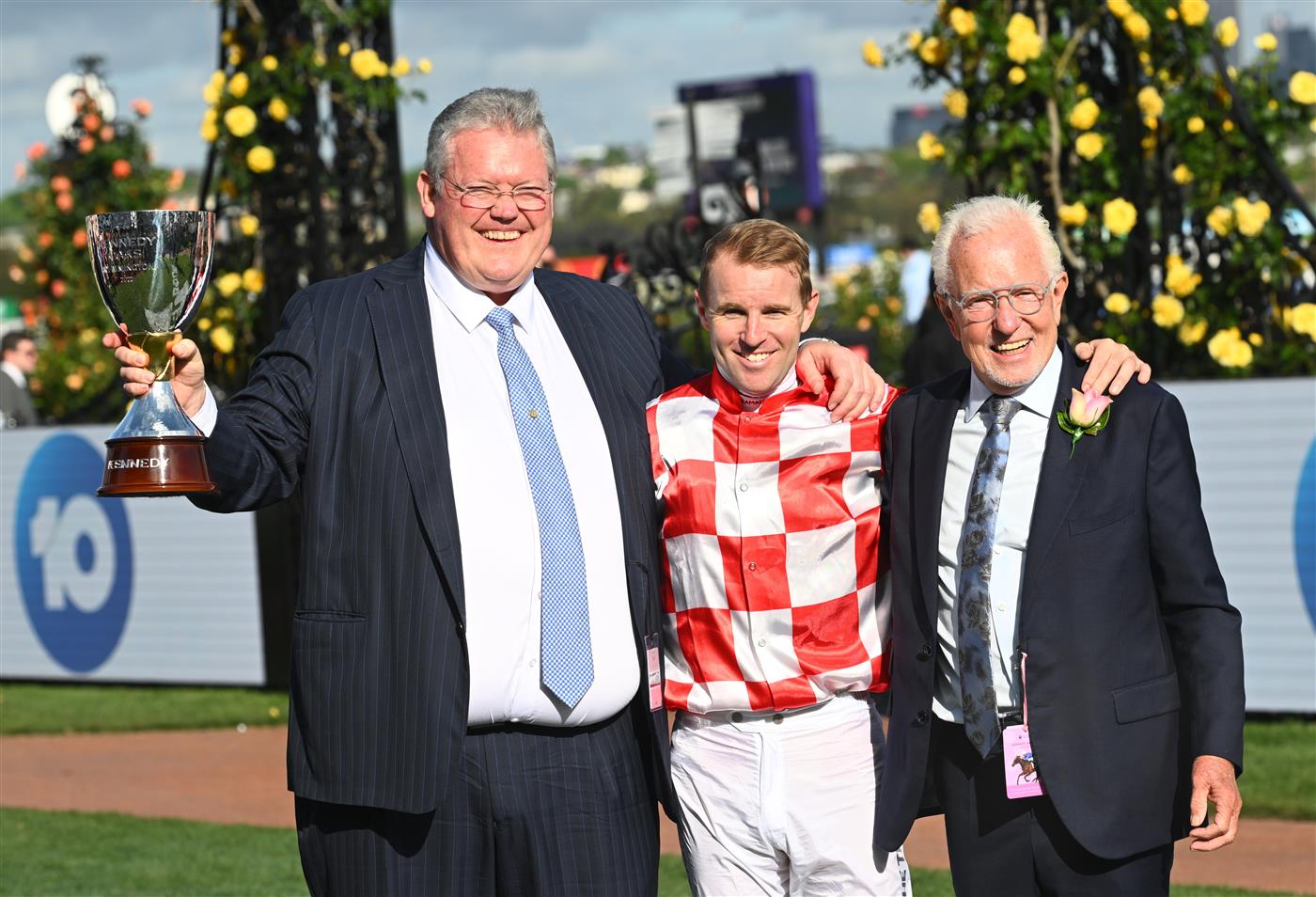 MELBOURNE, AUSTRALIA - NOVEMBER 03: Tommy Berry, trainer Anthony Cummings and owner Robert Crabtree pose with the Kennedy trophy.