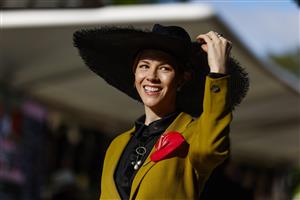 MELBOURNE, AUSTRALIA - NOVEMBER 03: A racegoer poses for a photo during 2022 Oaks Day at Flemington Racecourse on November 03, 2022 in Melbourne, Australia. (Photo by Luke Hemer/Getty Images for VRC)