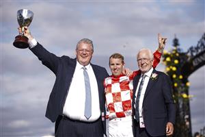MELBOURNE, AUSTRALIA - NOVEMBER 03: (L-R) Trainer Anthony Cummings, Tommy Berry, and owner Robert Crabtree pose with the Kennedy trophy.