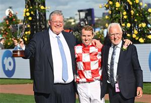 MELBOURNE, AUSTRALIA - NOVEMBER 03: Tommy Berry, trainer Anthony Cummings and owner Robert Crabtree pose with the Kennedy trophy.