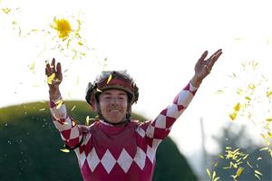 LEXINGTON, KENTUCKY - NOVEMBER 04: Jockey Tyler Gaffalione celebrates after riding Wonder Wheel to win the NetJets Breeders