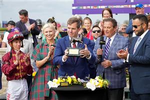 LEXINGTON, KENTUCKY - NOVEMBER 05: Kentucky governor Andy Beshear presents the trophy in the winner