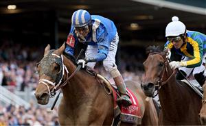 LEXINGTON, KENTUCKY - NOVEMBER 05: Jockey John Velazquez rides Malathaat to win the Longines Breeders