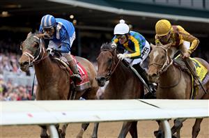LEXINGTON, KENTUCKY - NOVEMBER 05: Jockey John Velazquez rides Malathaat to win the Longines Breeders