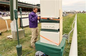 LEXINGTON, KENTUCKY - NOVEMBER 05: Maintenance workers secure a post due to wind during the 2022 Breeders