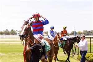 NEWCASTLE, AUSTRALIA - NOVEMBER 12: Jason Collett returns to scale after winning race 2, the TAB Highway Handicap during Racing at Newcastle Racecourse on November 12, 2022 in Newcastle, Australia. (Getty)