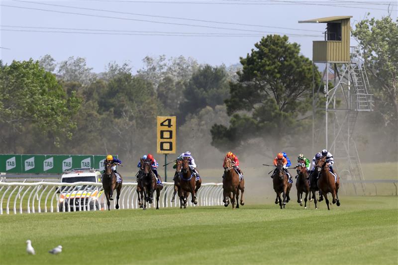 KEMBLA GRANGE, AUSTRALIA - NOVEMBER 19: Brock Ryan (orange, far right) on Cuban Royale wins race 6 the Traffic Logistics CG&E Benchmark 78 Handicap during Sydney Racing at Kembla Grange Racecourse on November 19, 2022 in Kembla Grange, Australia. (Photo by Mark Evans/Getty Images)