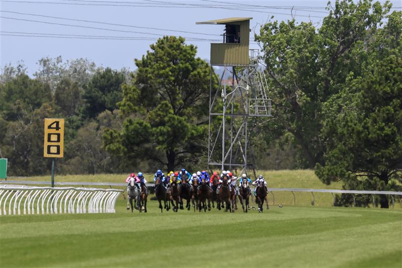 KEMBLA GRANGE, AUSTRALIA - NOVEMBER 19: Horses and jockeys round the bend for race 1 the Tab Highway Handicap during Sydney Racing at Kembla Grange Racecourse on November 19, 2022 in Kembla Grange, Australia. (Photo by Mark Evans/Getty Images)