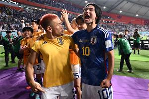 Japan's Yuto Nagatomo and Takumi Minamino celebrate with the crowd after the win (Getty Images)