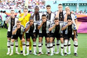 Germany players pose with their hands covering their mouths in protest (Getty Images)
