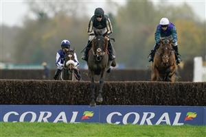 NEWBURY, ENGLAND - NOVEMBER 26: Harry Cobden riding McFabulous clear the water jump before going on to win The Coral John Francome Novices
