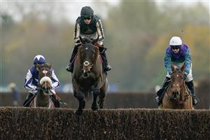 NEWBURY, ENGLAND - NOVEMBER 26: Harry Cobden riding McFabulous clear the water jump before going on to win The Coral John Francome Novices
