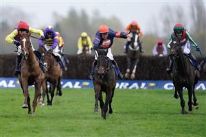 NEWBURY, ENGLAND - NOVEMBER 26: Harry Skelton riding Le Milos (orange cap) clear the last to win The Coral Gold Cup Handicap Chase at Newbury Racecourse on November 26, 2022 in Newbury, England. (Photo by Alan Crowhurst/Getty Images)