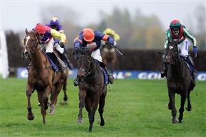 NEWBURY, ENGLAND - NOVEMBER 26: Harry Skelton riding Le Milos (orange cap) clear the last to win The Coral Gold Cup Handicap Chase at Newbury Racecourse on November 26, 2022 in Newbury, England. (Photo by Alan Crowhurst/Getty Images)