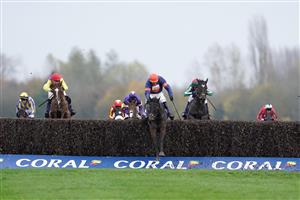 NEWBURY, ENGLAND - NOVEMBER 26: Harry Skelton riding Le Milos (orange cap) clear the last to win The Coral Gold Cup Handicap Chase at Newbury Racecourse on November 26, 2022 in Newbury, England. (Photo by Alan Crowhurst/Getty Images)